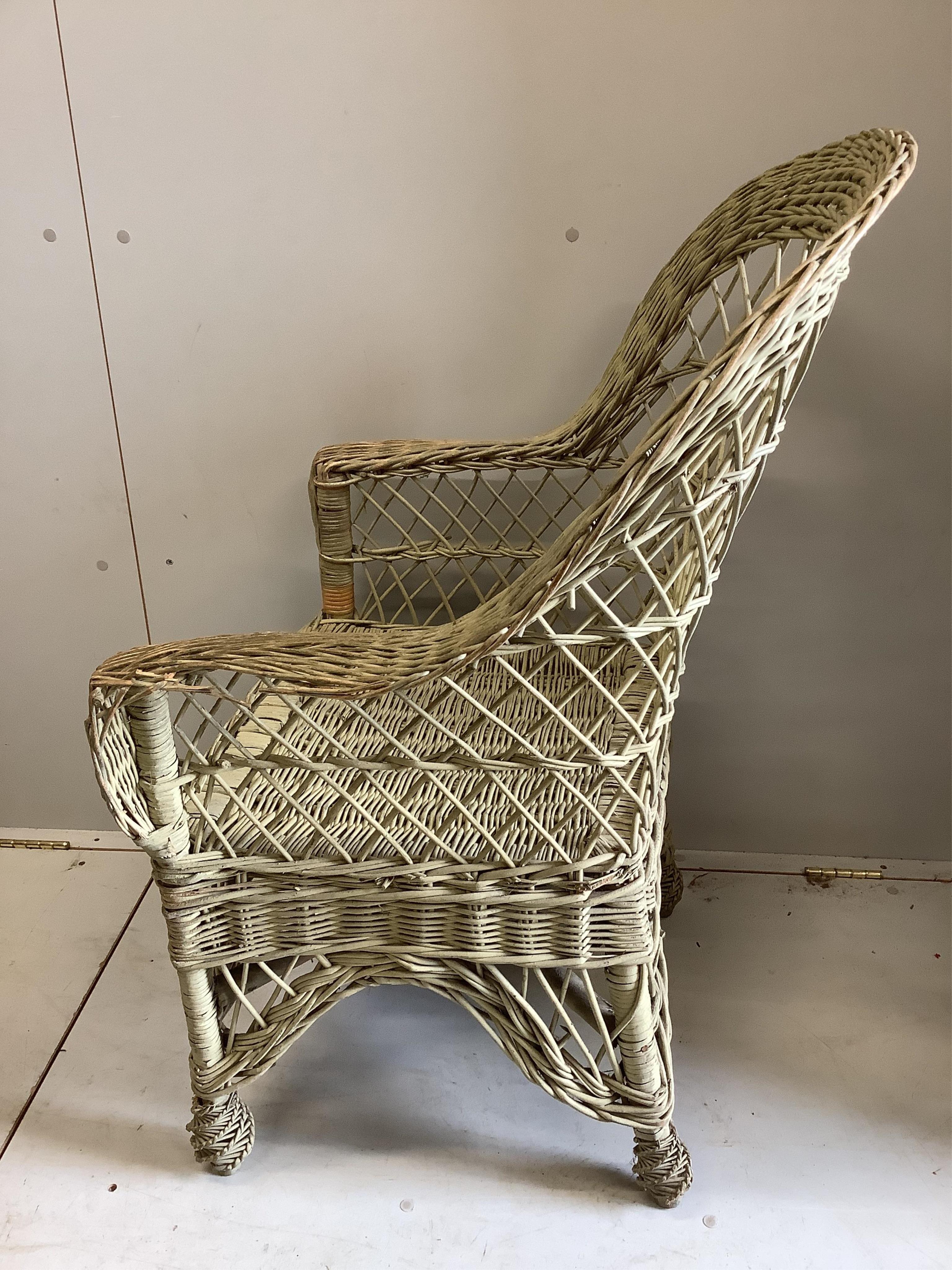 A vintage painted wicker garden armchair, width 64cm, depth 48cm, height 101cm. Condition - fair